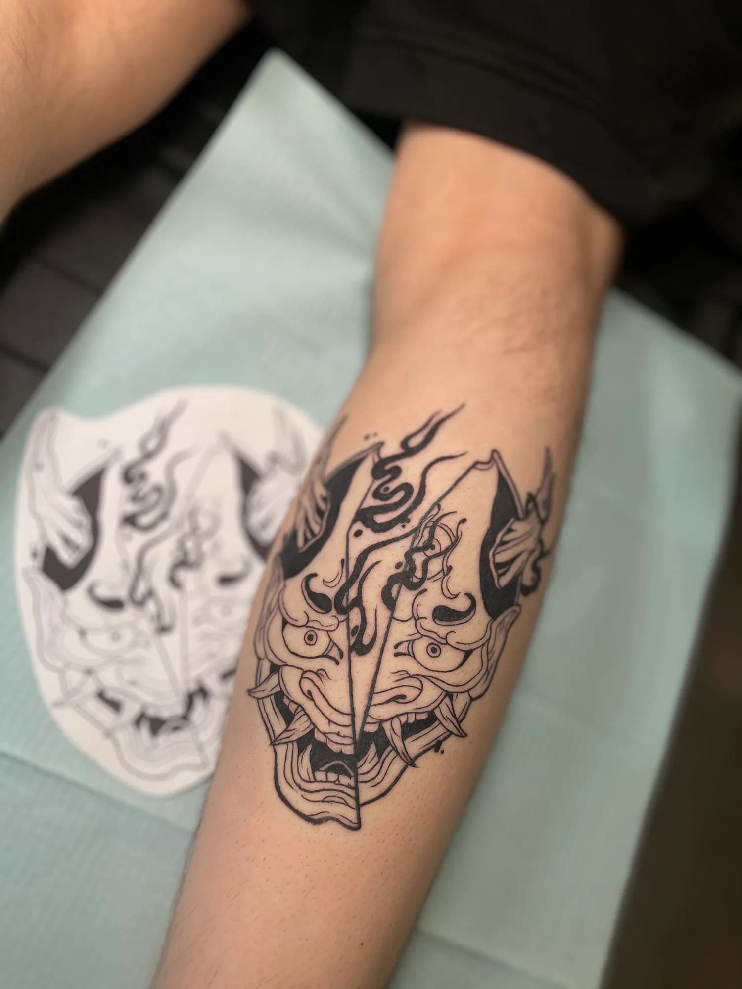 Black and grey new school Hannya split mask calf tattoo by Kamy Cao.