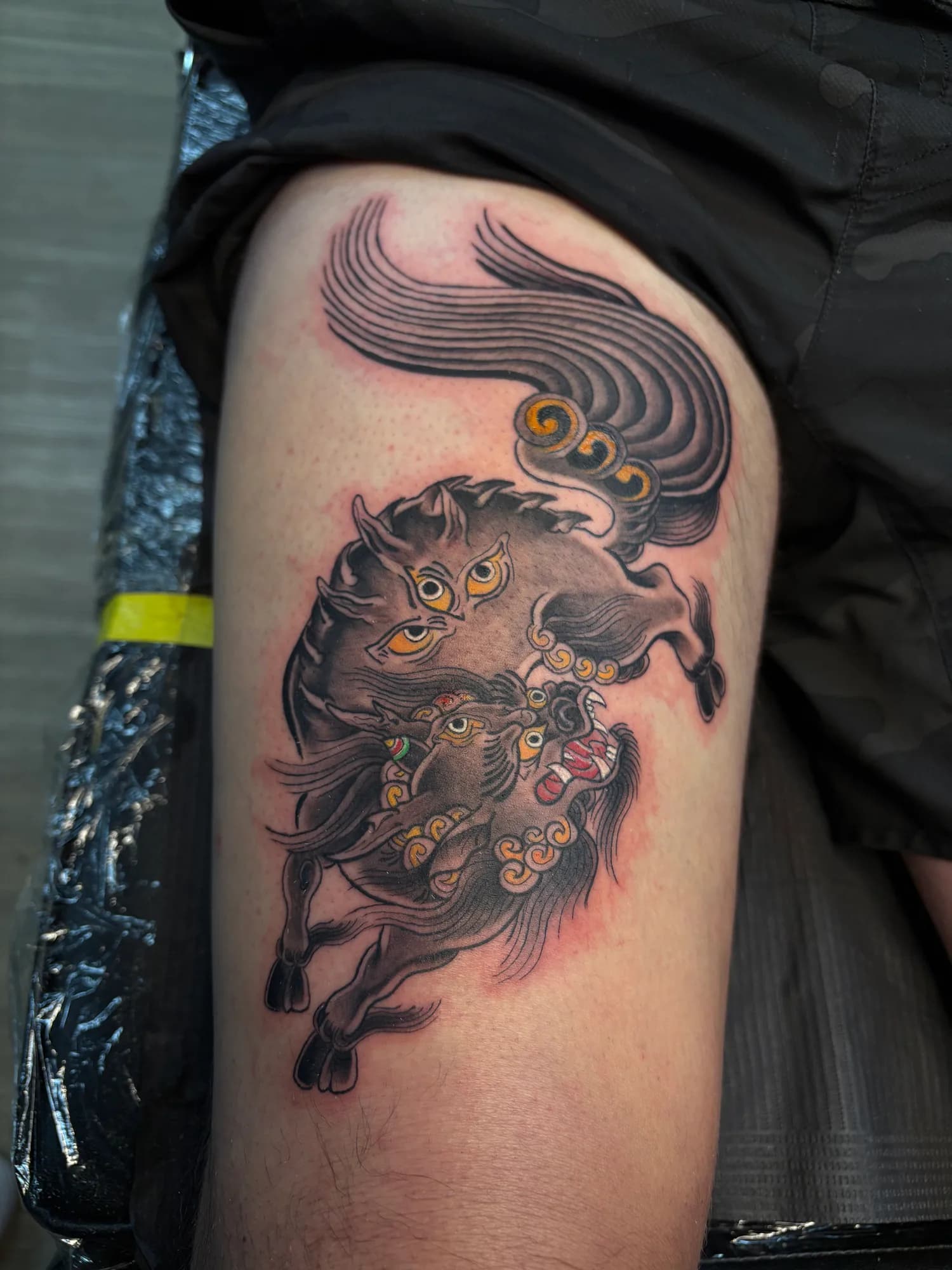 Black and grey Japanese Hakutaku thigh tattoo by Kamy Cao.
