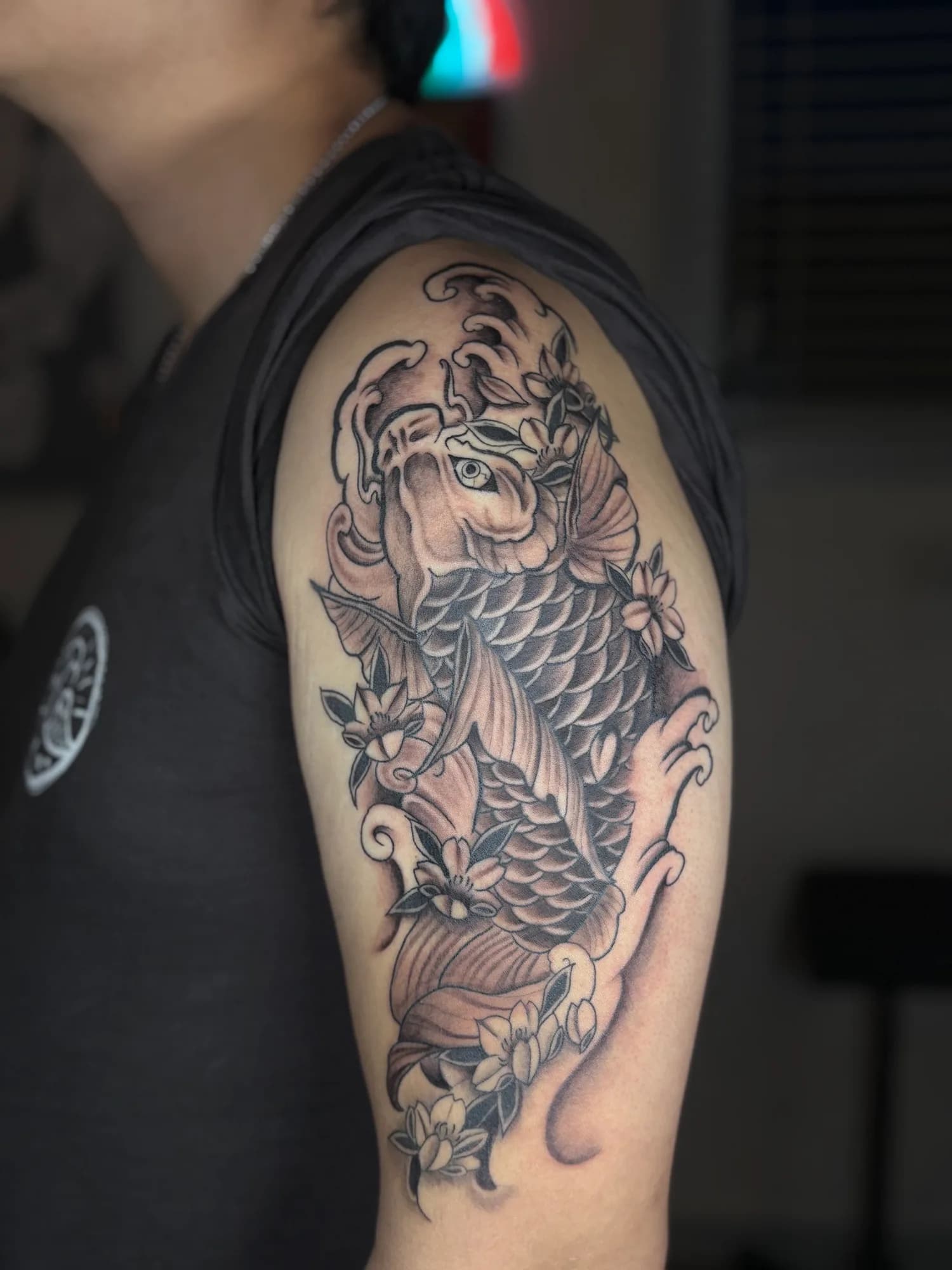 Black and grey Japanese koi fish shoulder tattoo by Kamy Cao.